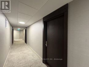 Mississauga (Hurontario) condo for rent - A hallway with a brokerage sign on the wall.