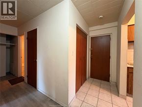 Windsor multi-family for rent - A hallway with two doors and a tiled floor.