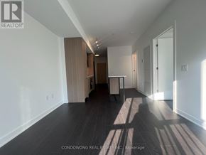 Toronto (Regent Park) condo for rent - A spacious room with wooden floors and white walls.