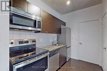 Toronto (Little Portugal) condo for rent - A kitchen with a stove top oven, microwave, and dishwasher.