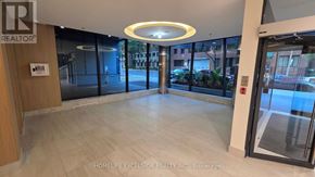 Toronto (Church-Yonge Corridor) condo for rent - A hallway with a glass door and a wooden door.