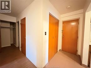 Windsor multi-family for rent - A hallway with two doors and a sign that says REALTOR.