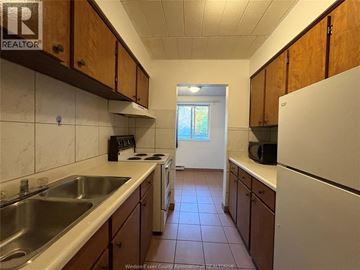 Windsor multi-family for rent - A kitchen with wooden cabinets and a white refrigerator.