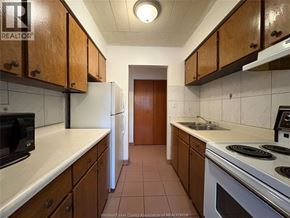 Windsor multi-family for rent - A kitchen with white appliances and brown cabinets.