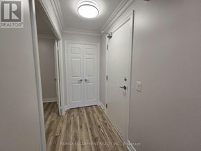 Oakville (Ro River Oaks) condo for rent - A white door with a black handle is in a room with a light on the ceiling.