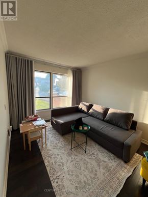 Brampton (Brampton West) apartment for rent - A living room with a couch, a table, and a rug.
