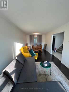 Brampton (Brampton West) apartment for rent - A grey couch with a yellow chair and a green table in a room.