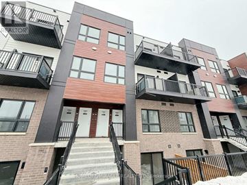 Kitchener townhouse for rent - A multi-story apartment building with balconies and staircases.