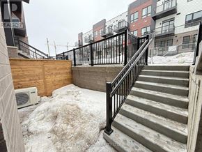 Kitchener townhouse for rent - A snow-covered staircase leads up to a building.