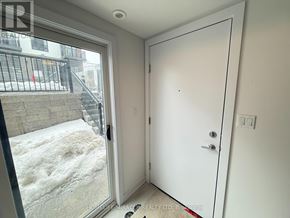 Kitchener townhouse for rent - A white door is open to a hallway.
