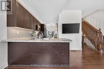 Vaughan (Beverley Glen) townhouse for rent - A kitchen with brown cabinets and a counter top.