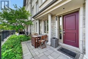 Vaughan (Beverley Glen) townhouse for rent - A house number 399 with a red door and a small table and chairs outside.