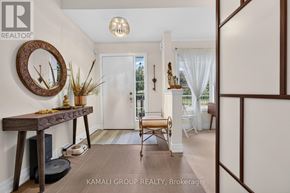 Vaughan (Beverley Glen) townhouse for rent - A hallway with a wooden table and a mirror on the wall.