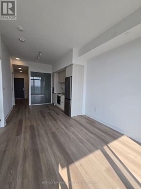 Mississauga (Cooksville) condo for rent - A spacious room with wooden flooring and white walls.