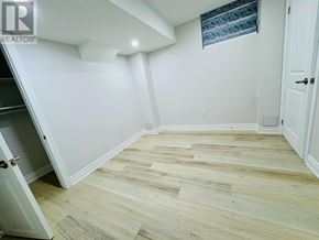 Oakville (Go Glenorchy) apartment for rent - A room with wooden flooring and white walls.