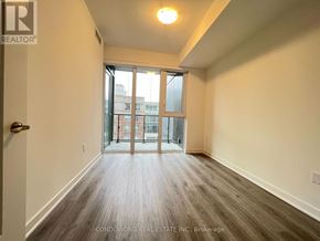 Toronto (Waterfront Communities) condo for rent - A room with a door and a window with a view of a building outside.