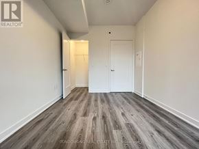 Toronto (Waterfront Communities) condo for rent - A room with wood flooring and white walls.