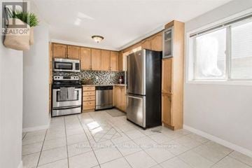 Cambridge apartment for rent - A kitchen with a refrigerator, oven, and microwave.