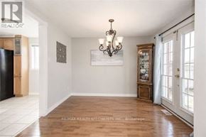 Cambridge apartment for rent - A well-lit room with a chandelier, a framed picture on the wall, and a wooden cabinet.