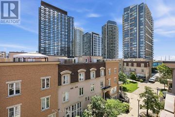 Toronto (Niagara) townhouse for rent - A cityscape with a mix of modern and older buildings, with the logo "REALTOR" visible on the top left.