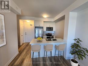 Lincoln (Lincoln Lake) condo for rent - A kitchen with a white countertop and bar stools.