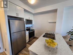 Lincoln (Lincoln Lake) condo for rent - A kitchen with a refrigerator, microwave, and a bowl of lemons on the counter.