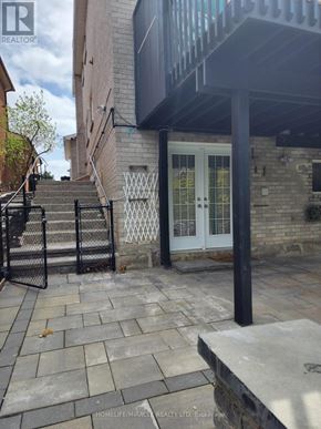 Mississauga (Streetsville) apartment for rent - A stone patio leads to a white door.