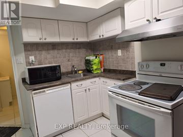 Toronto (Birchcliffe-Cliffside) apartment for rent - A kitchen with white cabinets and a white stove top oven.