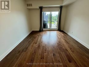 Mississauga (Erin Mills) condo for rent - A room with wooden flooring and a sliding glass door.