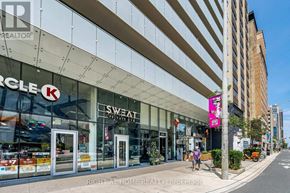Toronto (Annex) condo for rent - A street view of a building with a K-Mart and Sweat Shop on the ground floor.
