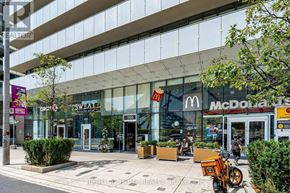 Toronto (Annex) condo for rent - A McDonald's restaurant is located in a modern building with a glass facade.