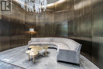 Toronto (Annex) condo for rent - A modern living room with a grey sofa and a round coffee table.