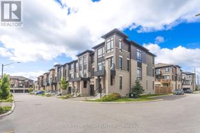 Whitby (Brooklin) townhouse for rent - A street view of a residential area with apartment buildings and a car parked on the side of the road.