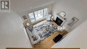 Markham (Cachet) apartment for rent - A living room with a fireplace and a rug.