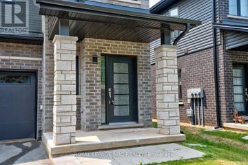 Niagara Falls (Morrison) townhouse for rent - A house with a grey garage door and a black door with a glass window.