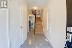 Niagara Falls (Morrison) townhouse for rent - A hallway with a staircase and a door.
