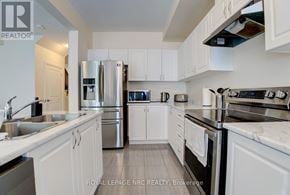 Niagara Falls (Morrison) townhouse for rent - A white kitchen with a sink and stove.