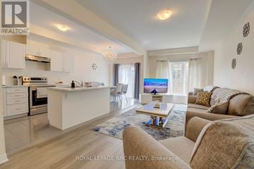 Niagara Falls (Morrison) townhouse for rent - A well-lit, spacious kitchen and living room with a couch and a coffee table.