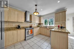 Newmarket (Woodland Hill) apartment for rent - A kitchen with wooden cabinets and a granite countertop.