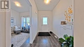 Norfolk (Simcoe) townhouse for rent - A hallway with a door and a plant on the right side.