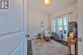 Norfolk (Simcoe) townhouse for rent - A living room with a grey couch and a white rug.