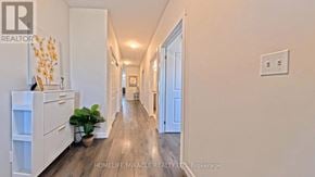 Norfolk (Simcoe) townhouse for rent - A long hallway with a plant on the left and a door on the right.