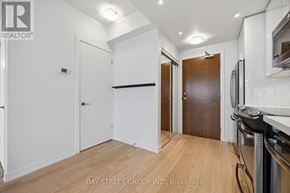 Toronto (Mimico) condo for rent - A kitchen area with a refrigerator, oven, and microwave.