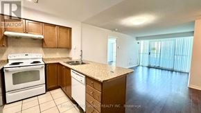 Toronto (Willowdale East) condo for rent - A kitchen with white appliances and wooden cabinets.