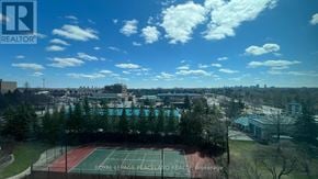 Markham (Aileen-Willowbrook) condo for rent - A tennis court is seen from above with a blue sky and clouds in the background.