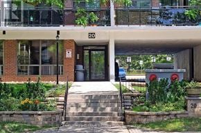 Toronto (Eglinton East) condo for rent - A building with the number 20 on it has a small garden in front.