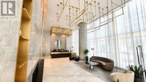 Vaughan (Vaughan Corporate Centre) condo for rent - A modern office lobby with a reception desk and a large window.