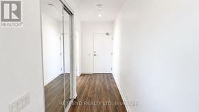 Vaughan (Vaughan Corporate Centre) condo for rent - A hallway with a wooden floor and white walls.