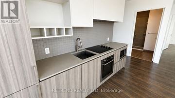 Vaughan (Vaughan Corporate Centre) condo for rent - A kitchen with a sink and a stove top oven.