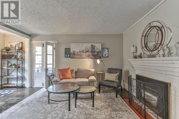 London East (East B) multi-family for rent - A living room with a fireplace and a painting on the wall.